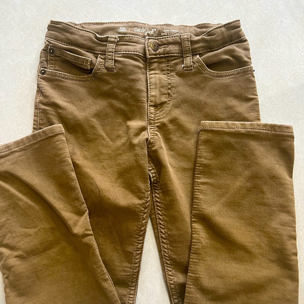 Tan jeans. Slim cut.  Super stretch material with adjustable waist band.